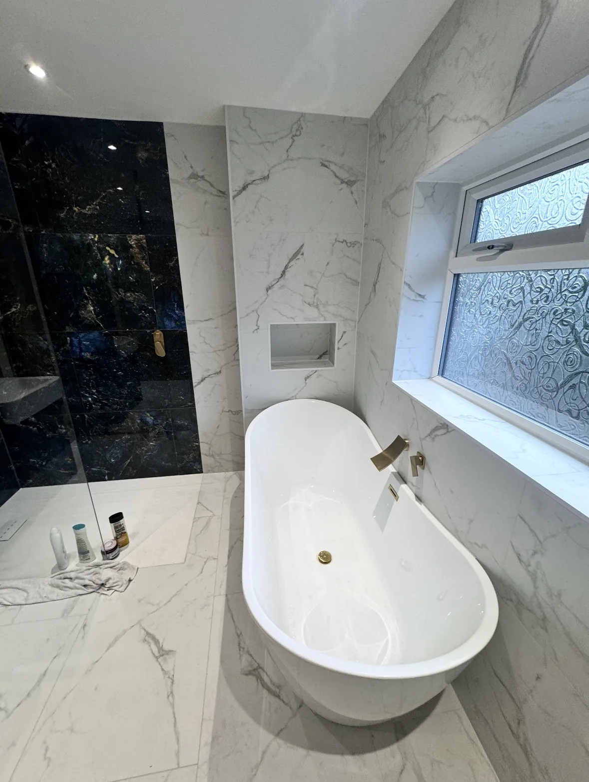 Finished bathroom with a freestanding bath and gold wall taps installed by RC Renovation