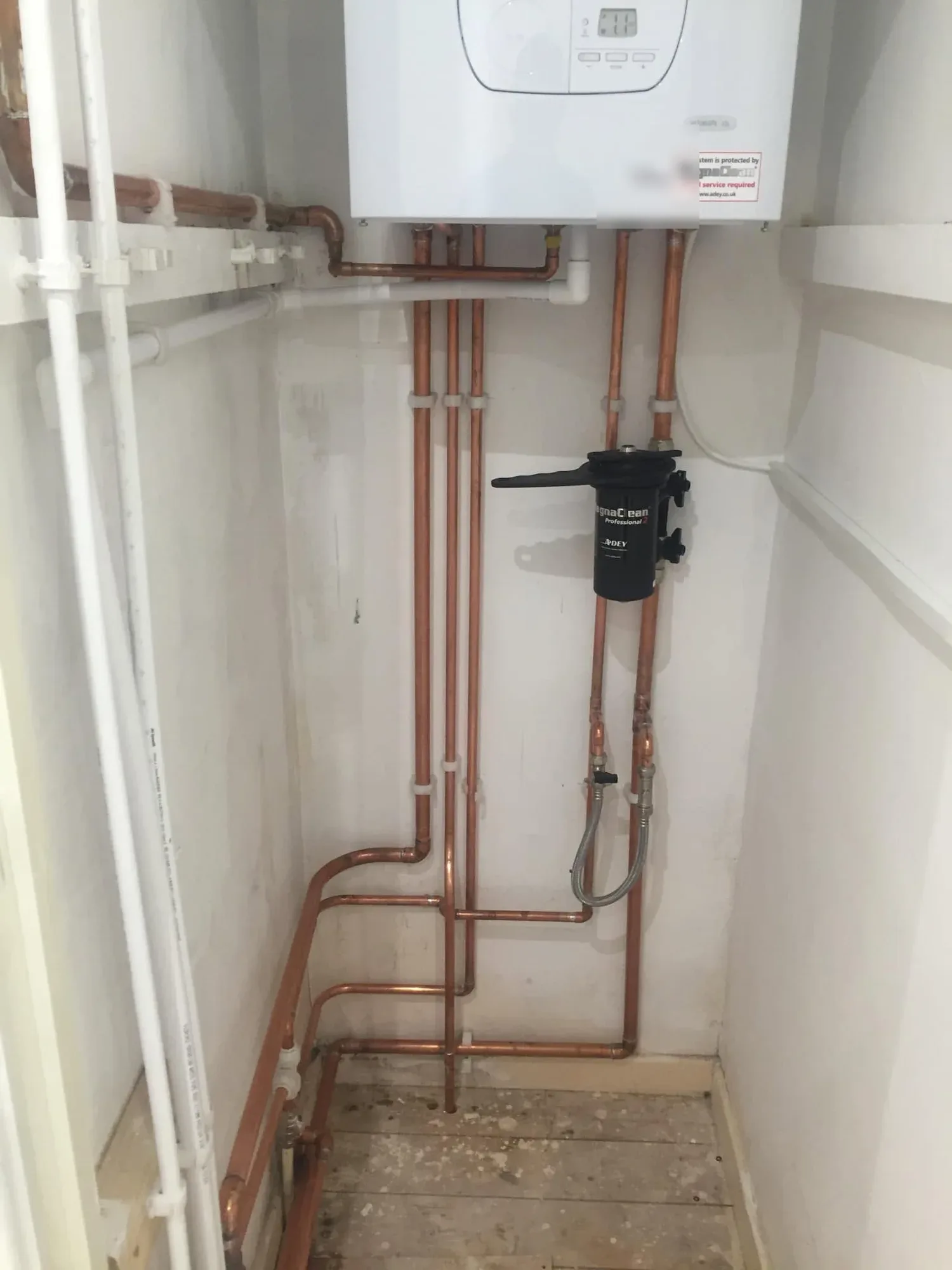 Copper pipework and system filter beneath a new Glow-worm boiler