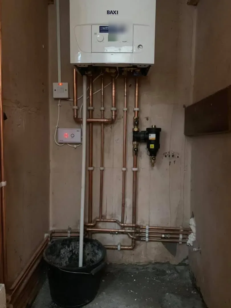 Wide view of a Baxi combi boiler cupboard after installation
