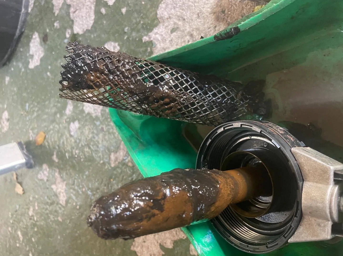 Sludge-coated filter magnet removed from a heating system